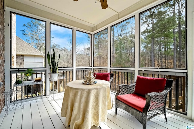 sunroom / solarium featuring a ceiling fan and a wealth of natural light