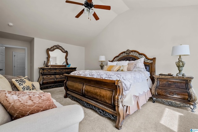 carpeted bedroom featuring lofted ceiling and a ceiling fan