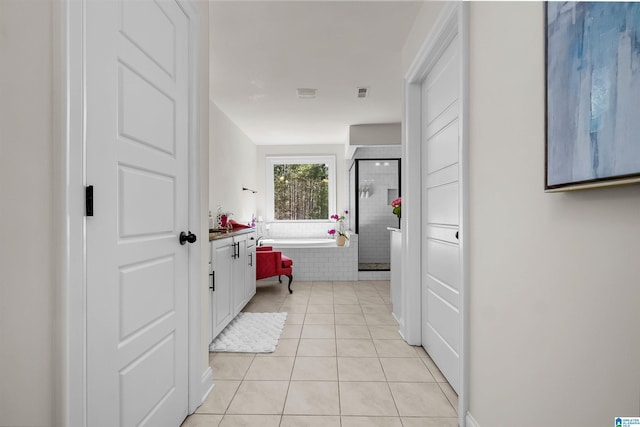 hallway with light tile patterned floors and visible vents