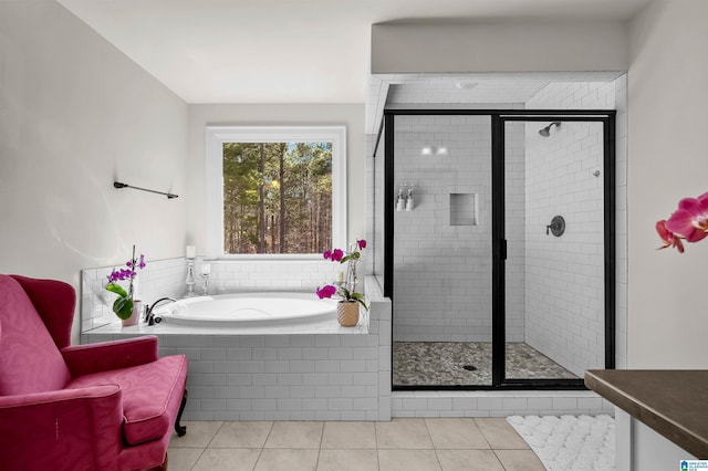 full bathroom with a stall shower, tile patterned flooring, and a bath