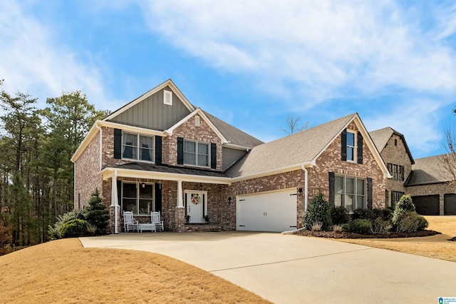 craftsman house featuring concrete driveway, brick siding, board and batten siding, and an attached garage