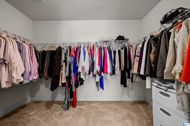 walk in closet featuring carpet