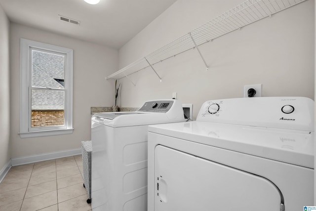 laundry room featuring visible vents, light tile patterned flooring, laundry area, independent washer and dryer, and baseboards