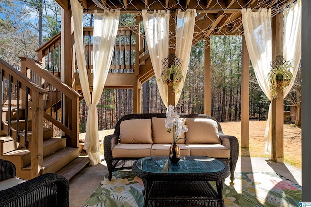 view of patio featuring stairway, outdoor lounge area, and fence