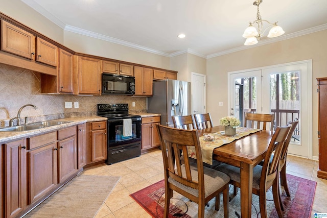 kitchen featuring a sink, light countertops, backsplash, black appliances, and brown cabinetry