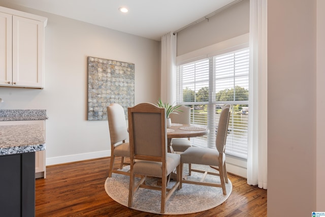 dining room with dark wood-style flooring, recessed lighting, and baseboards