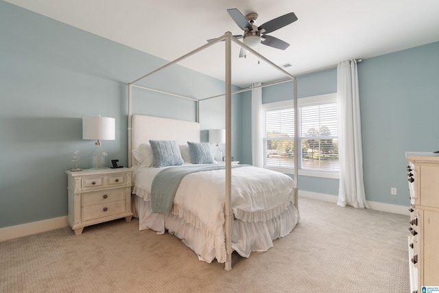bedroom featuring light carpet, visible vents, baseboards, and a ceiling fan