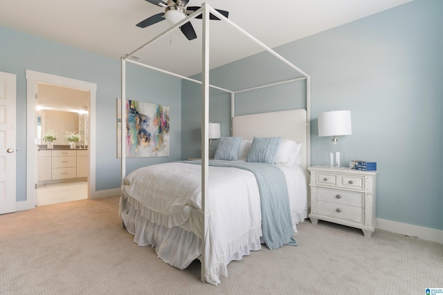 bedroom with light carpet, ceiling fan, baseboards, and ensuite bathroom