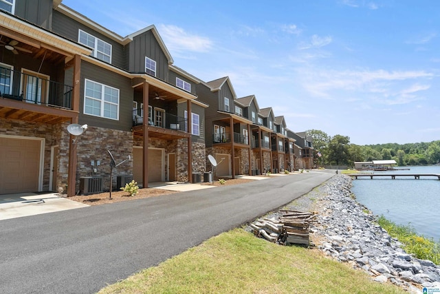 view of road featuring a water view and a residential view