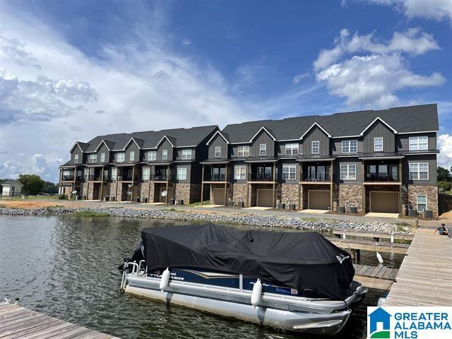 view of dock featuring a water view and a residential view