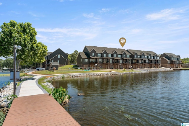 dock area with a residential view and a water view
