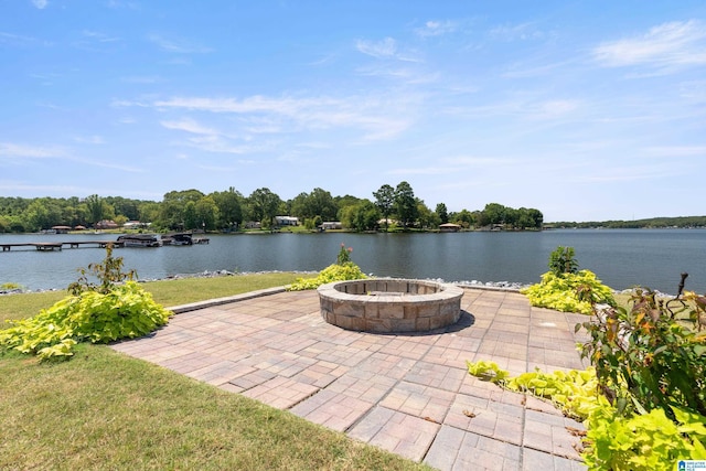 view of patio with a water view and an outdoor fire pit