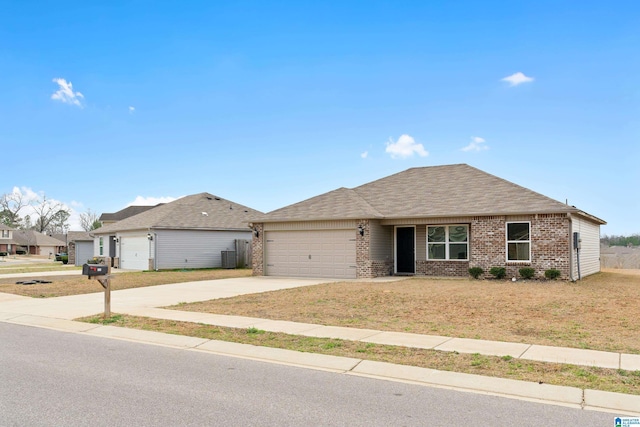 207 Hidden Trace Ct, Montevallo, AL 35115 - single story home featuring brick siding, a shingled roof, concrete driveway, an attached garage, and a front yard
