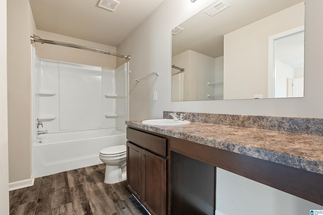 full bathroom featuring toilet, visible vents, wood finished floors, and vanity