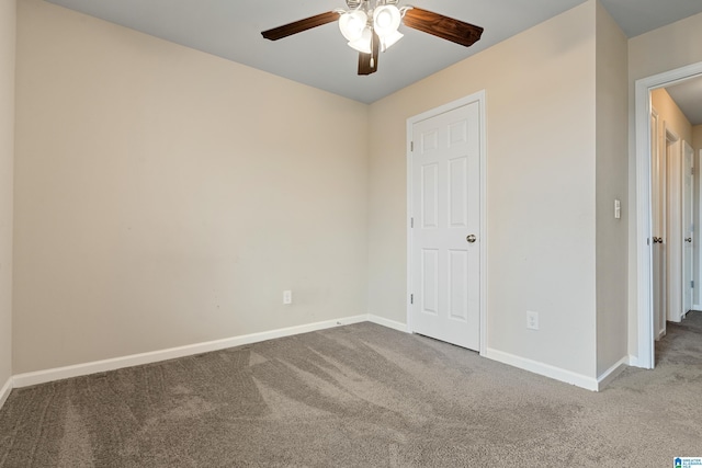 unfurnished bedroom featuring carpet floors, baseboards, and a ceiling fan