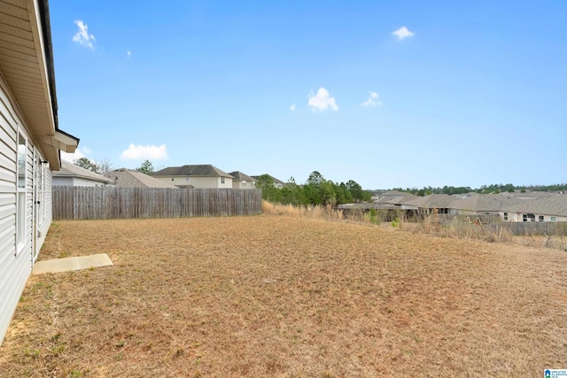 view of yard featuring a residential view and fence