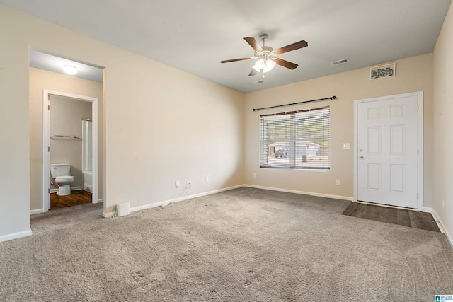 interior space with baseboards, visible vents, and a ceiling fan