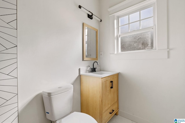 half bath featuring toilet, vanity, and baseboards