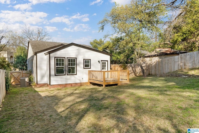 rear view of property featuring a yard, cooling unit, a wooden deck, and a fenced backyard