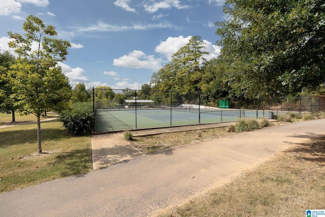 view of tennis court featuring fence