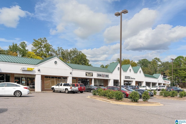 view of building exterior featuring uncovered parking