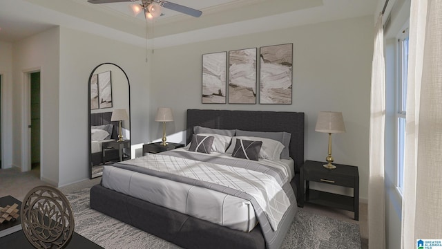 bedroom featuring ceiling fan, carpet floors, ornamental molding, and a raised ceiling