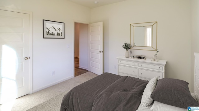 bedroom featuring carpet floors and baseboards