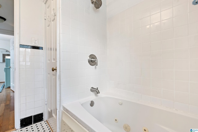 bathroom with tile patterned flooring, tile walls, and a combined bath / shower with jetted tub