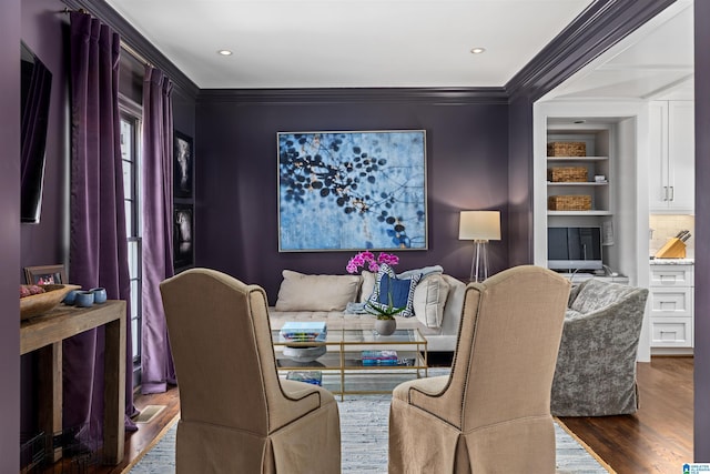 dining space featuring built in features, ornamental molding, wood finished floors, and recessed lighting