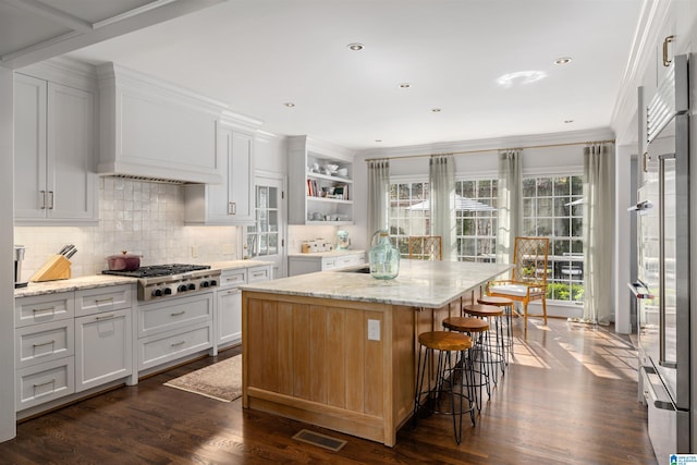 kitchen featuring stainless steel appliances, a healthy amount of sunlight, visible vents, and open shelves