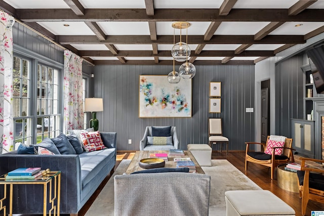 living room with beam ceiling, coffered ceiling, a wealth of natural light, and wood finished floors