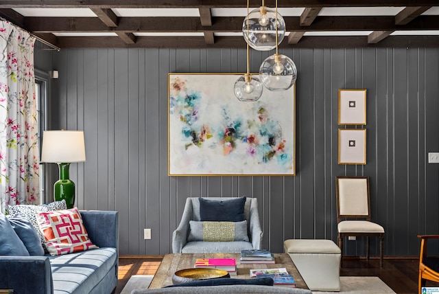 living room featuring beam ceiling, coffered ceiling, and wood finished floors