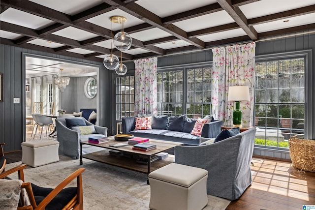 living room featuring beamed ceiling, coffered ceiling, and a wealth of natural light