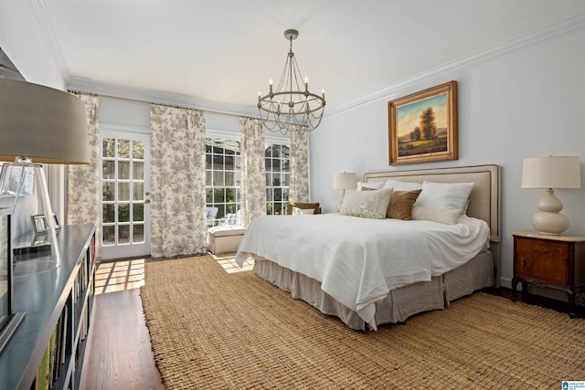 bedroom with a notable chandelier, ornamental molding, and wood finished floors