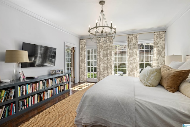 bedroom with a chandelier, wood finished floors, and crown molding