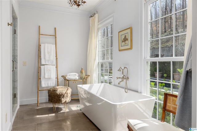 interior space with a chandelier, crown molding, and baseboards