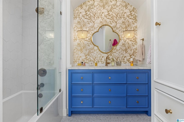 full bath featuring wallpapered walls, washtub / shower combination, and vanity