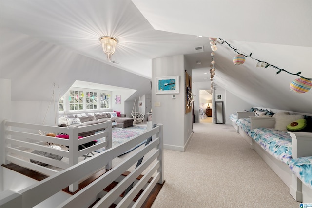 bedroom with lofted ceiling, light carpet, and visible vents