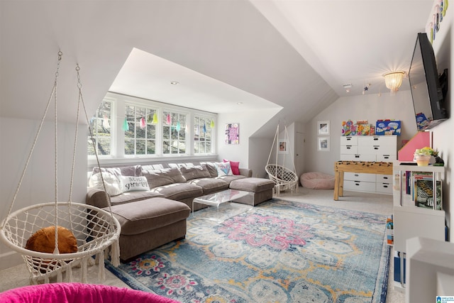 carpeted living area with vaulted ceiling