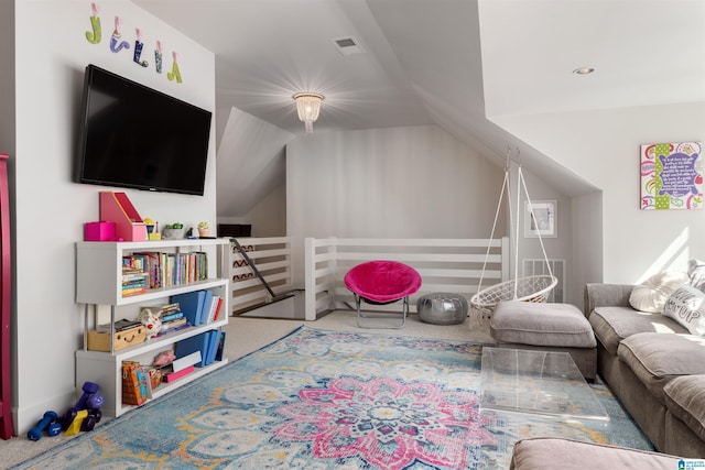 recreation room featuring vaulted ceiling, carpet, and visible vents