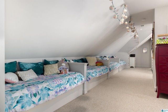 bedroom with vaulted ceiling, carpet flooring, and visible vents