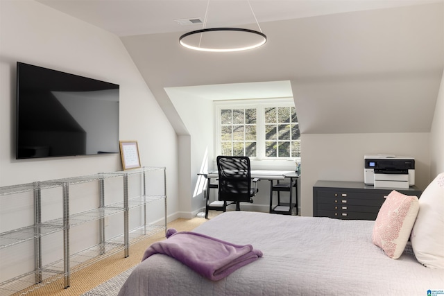 carpeted bedroom with lofted ceiling, baseboards, and visible vents