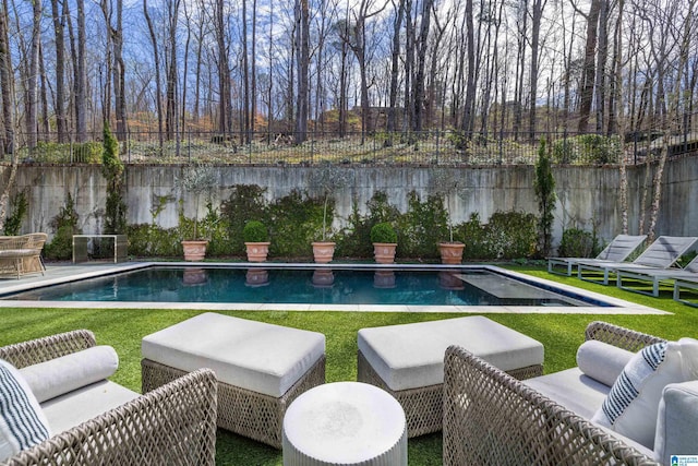 view of pool with a fenced in pool, a fenced backyard, and an outdoor hangout area