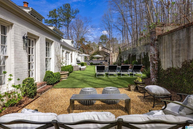 exterior space with entry steps, fence, and outdoor lounge area