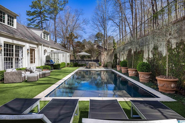 view of pool with a fenced in pool, a lawn, an outdoor hangout area, fence, and a patio area