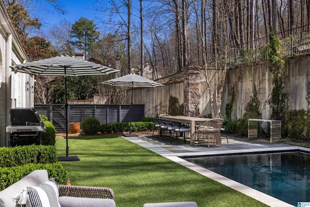 view of yard with a patio, fence, and a fenced in pool