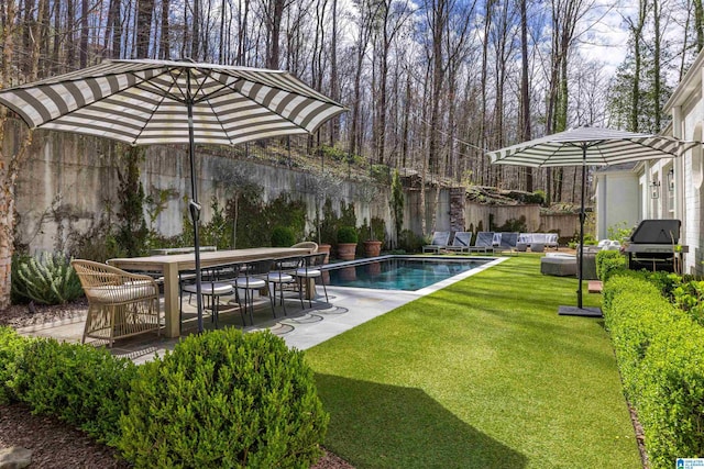 pool featuring outdoor dining area, a patio, outdoor lounge area, a lawn, and fence