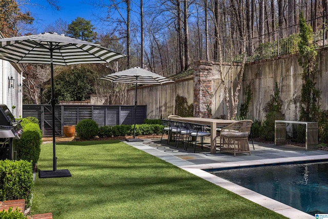 view of yard featuring outdoor dining space, an outdoor pool, a patio, and fence