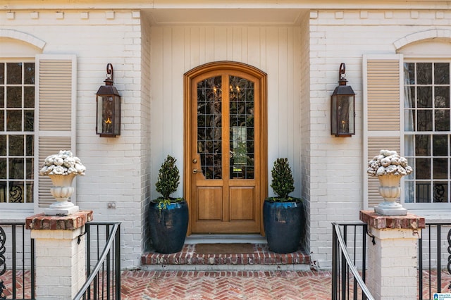 doorway to property with brick siding