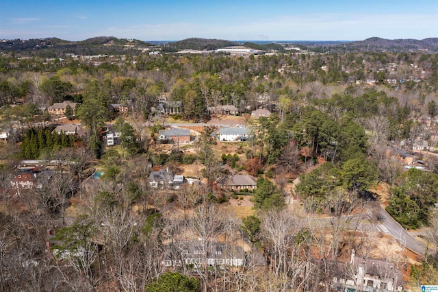 birds eye view of property featuring a mountain view and a view of trees